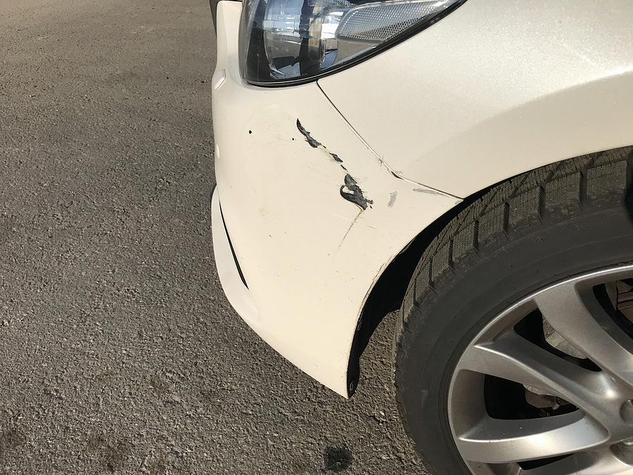 white car that needs paintless dent repair on car scratch